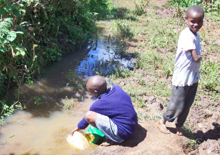 Gathering water in plastic jugs to use for cooking