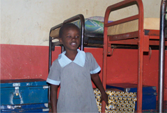 Charity stainding in front of her bed